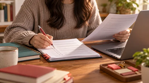 Student carefully checking application documents with a pencil